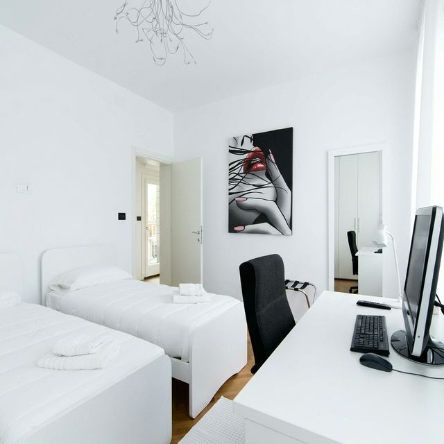 BRW House twin room — two single white beds, pop art painting, desk