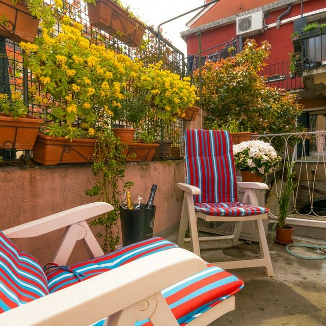 BRW House terrace close-up — colorful striped chairs, yellow flower pots, hydrangeas